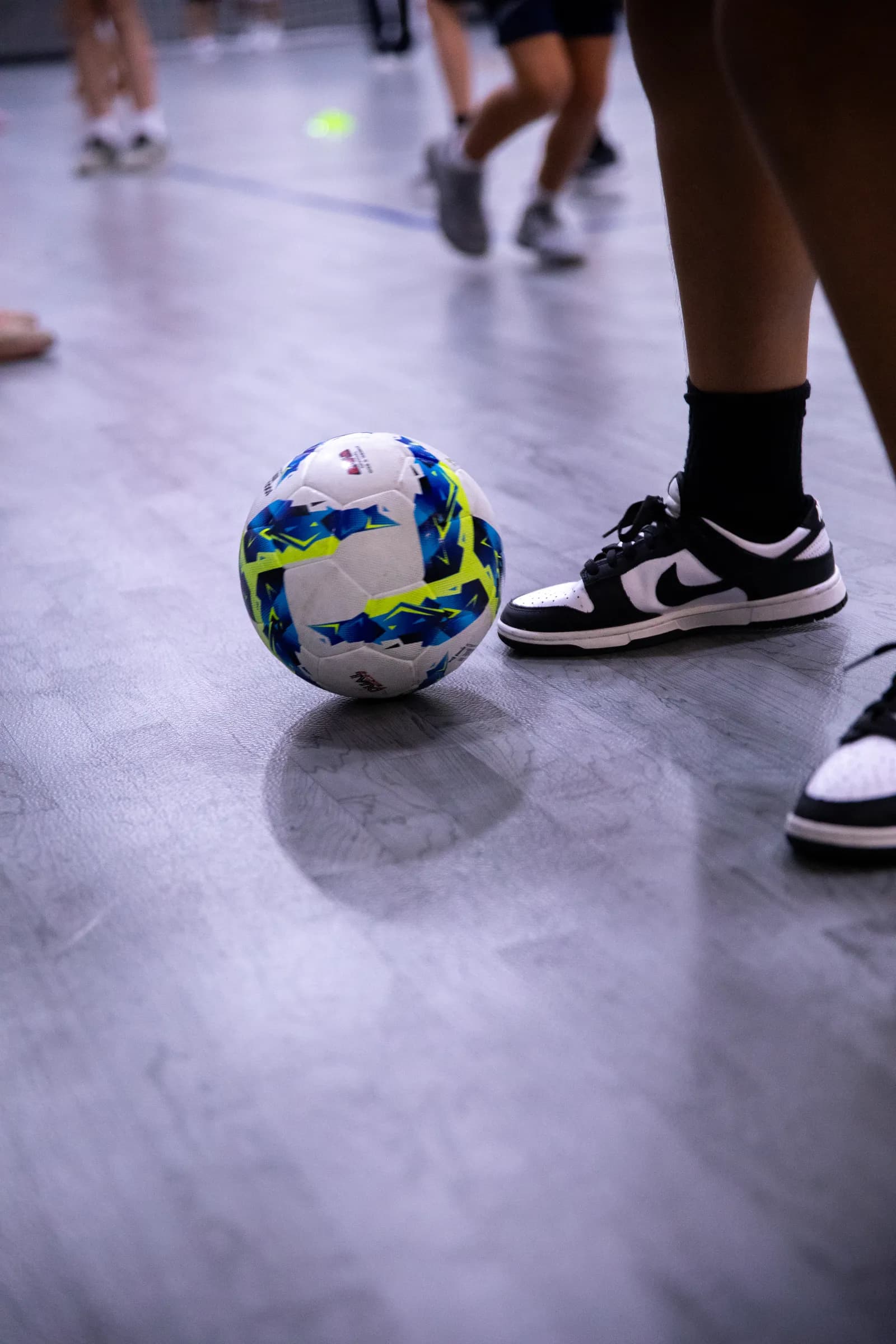 Players training with futsal balls on the indoor court at Frontrunner Fieldhouse in Fort Worth